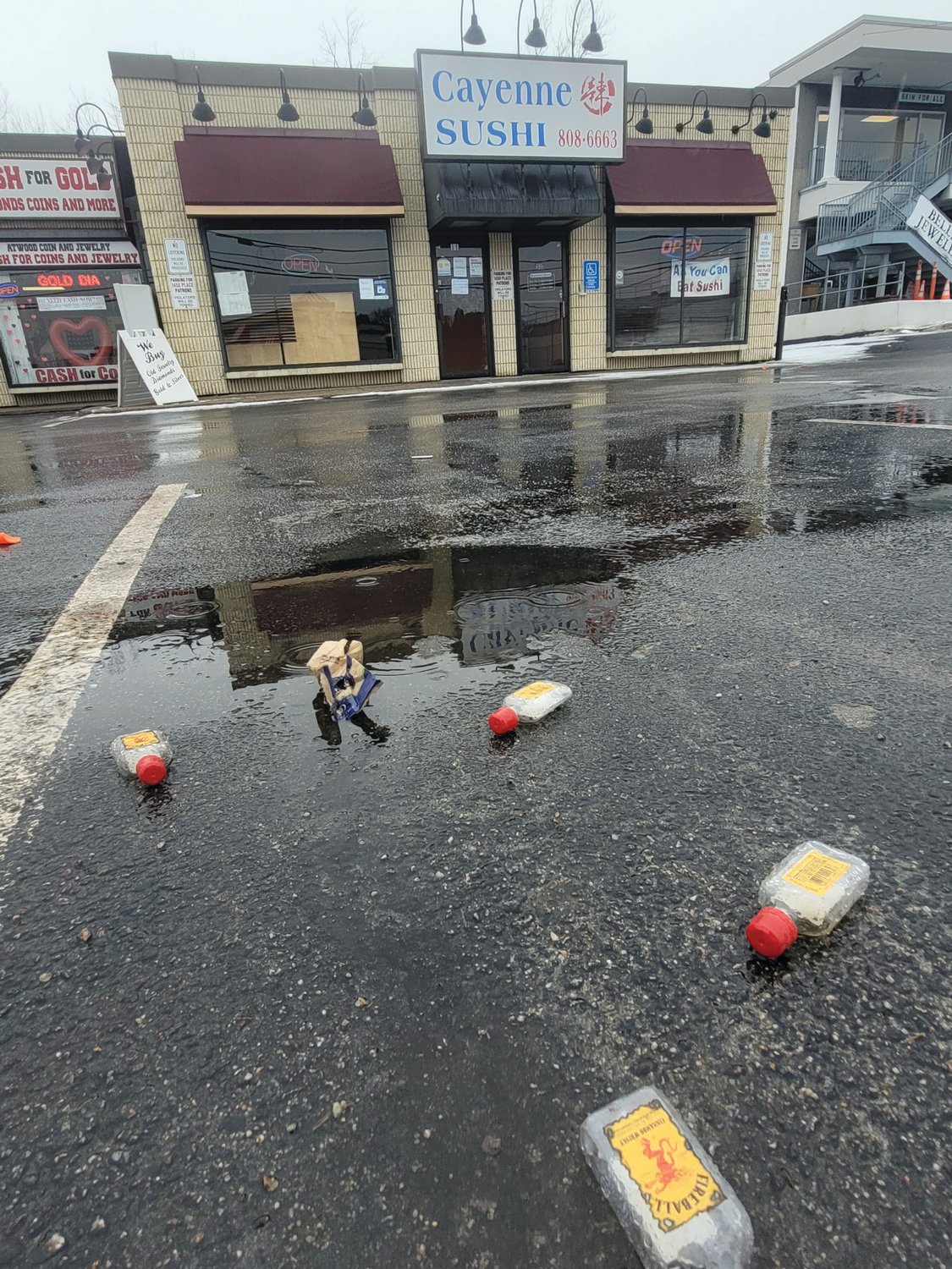 FIREBALL LITTER: Four freshly dropped nips litter the parking lot outside Cayenne Sushi on Atwood Avenue in Johnston. The snow had been plowed recently, so the bottles were carelessly tossed recently.